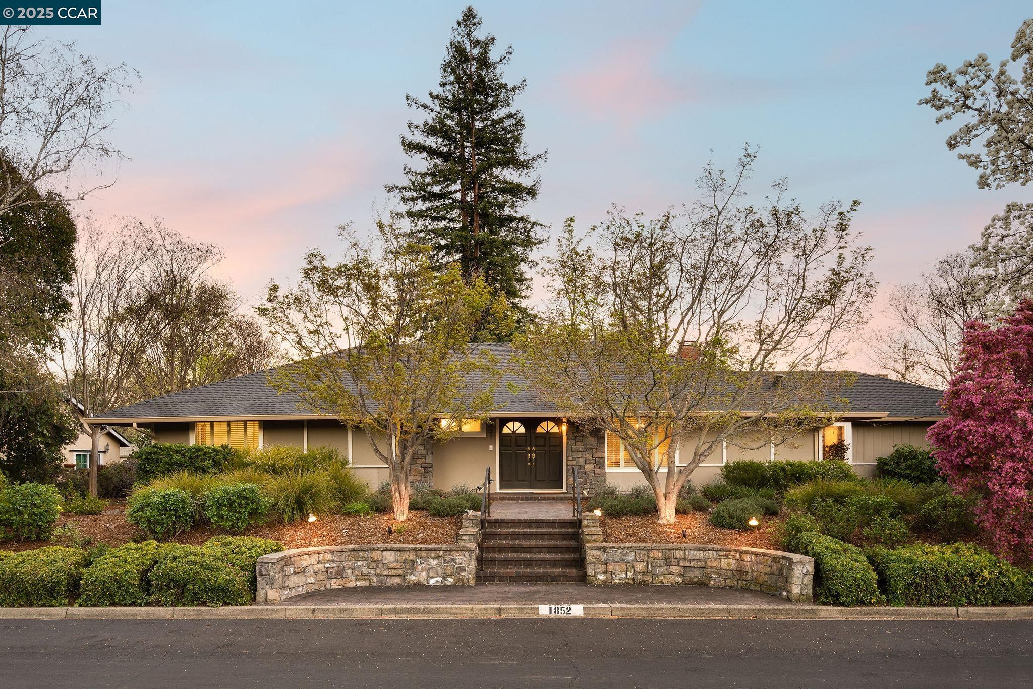 a front view of a house with a garden
