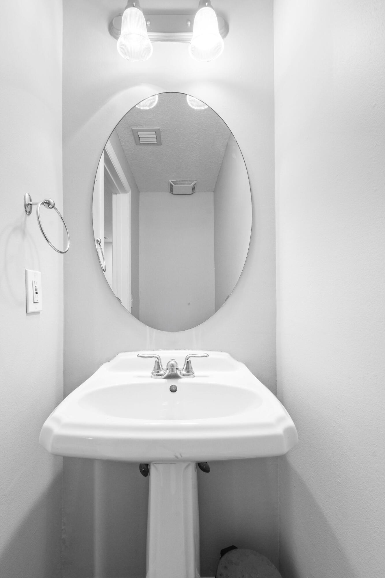 175 Galicia Way, Unit 211 Jupiter, FL 33458 - Photo 13 of 49 a bathroom with a sink and mirror