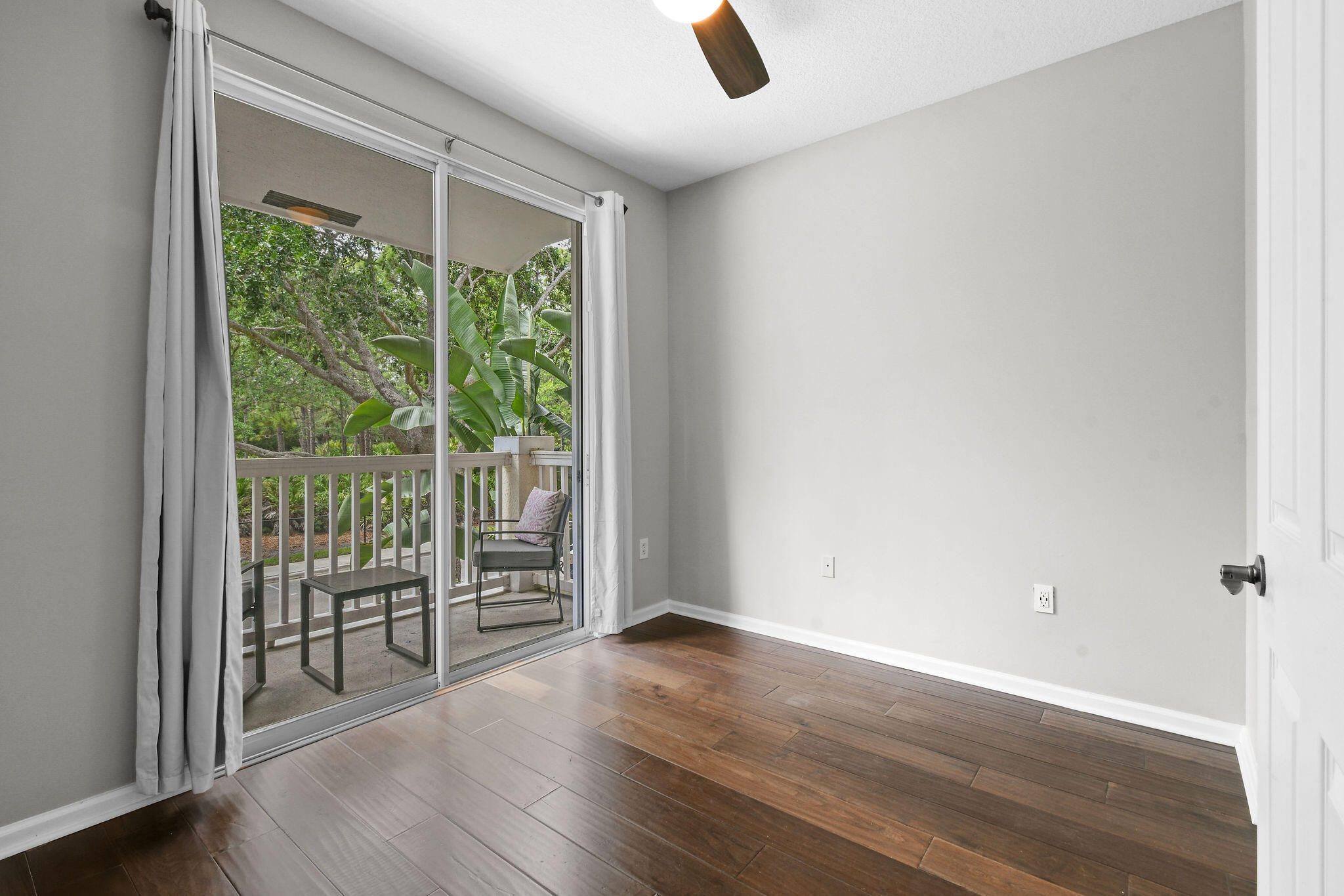 175 Galicia Way, Unit 211 Jupiter, FL 33458 - Photo 14 of 49 an empty room with wooden floor and windows
