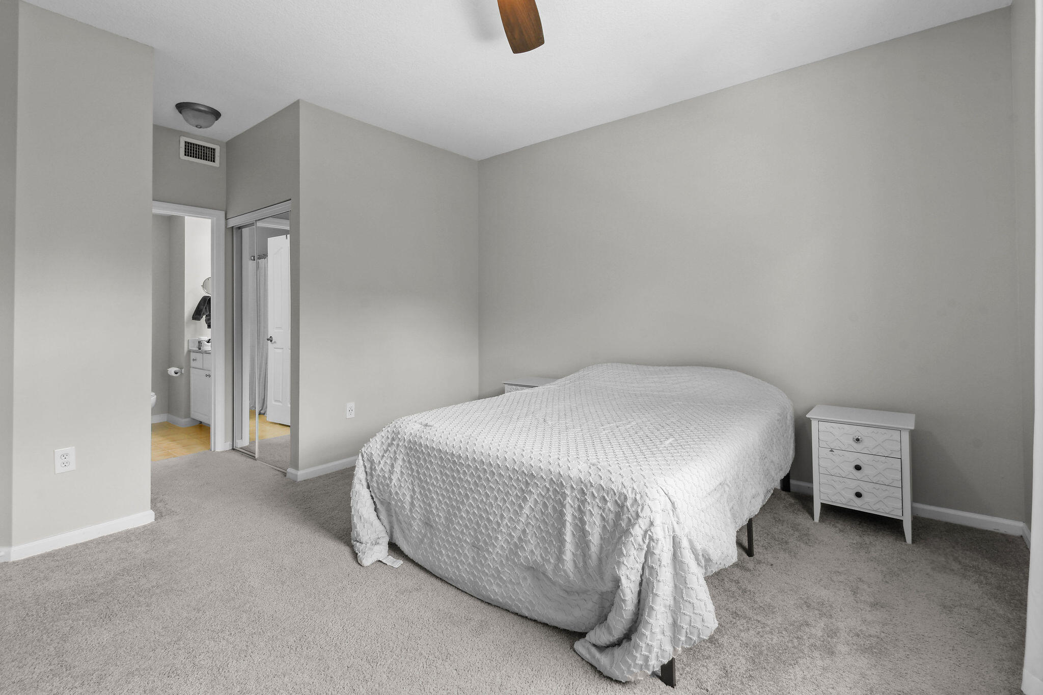 175 Galicia Way, Unit 211 Jupiter, FL 33458 - Photo 21 of 49 a bedroom with a bed and cabinets