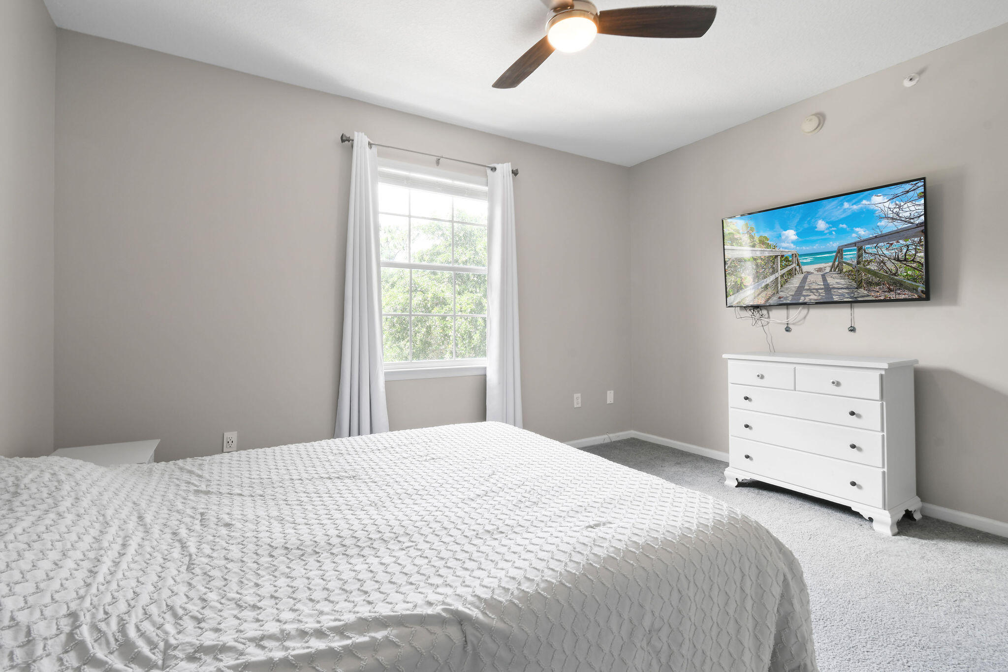 175 Galicia Way, Unit 211 Jupiter, FL 33458 - Photo 22 of 49 a bedroom with a bed and a flat screen tv