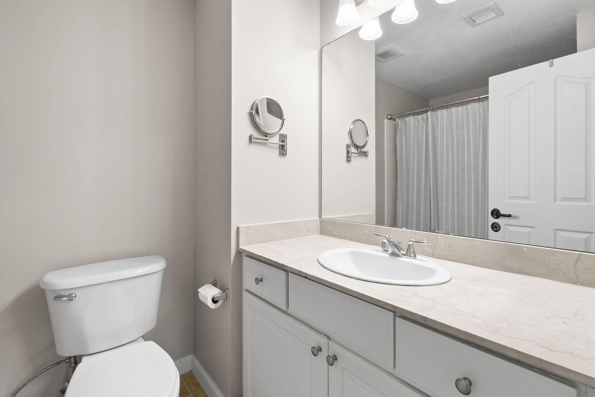 175 Galicia Way, Unit 211 Jupiter, FL 33458 - Photo 24 of 49 a bathroom with a toilet sink and mirror