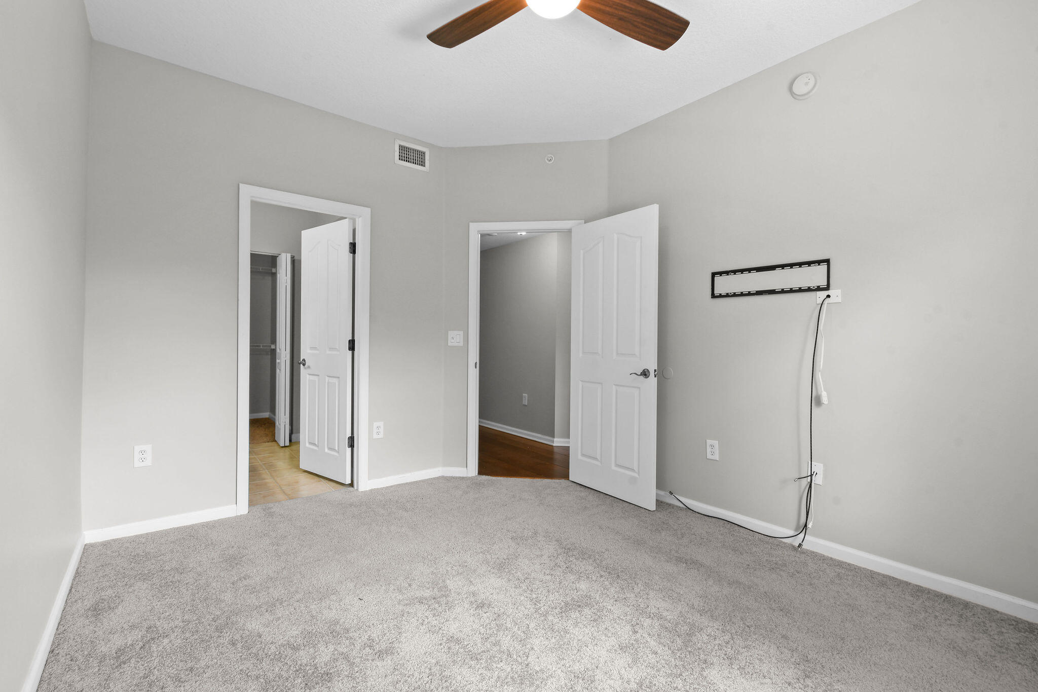 175 Galicia Way, Unit 211 Jupiter, FL 33458 - Photo 27 of 49 an empty room with closet and a chandelier fan