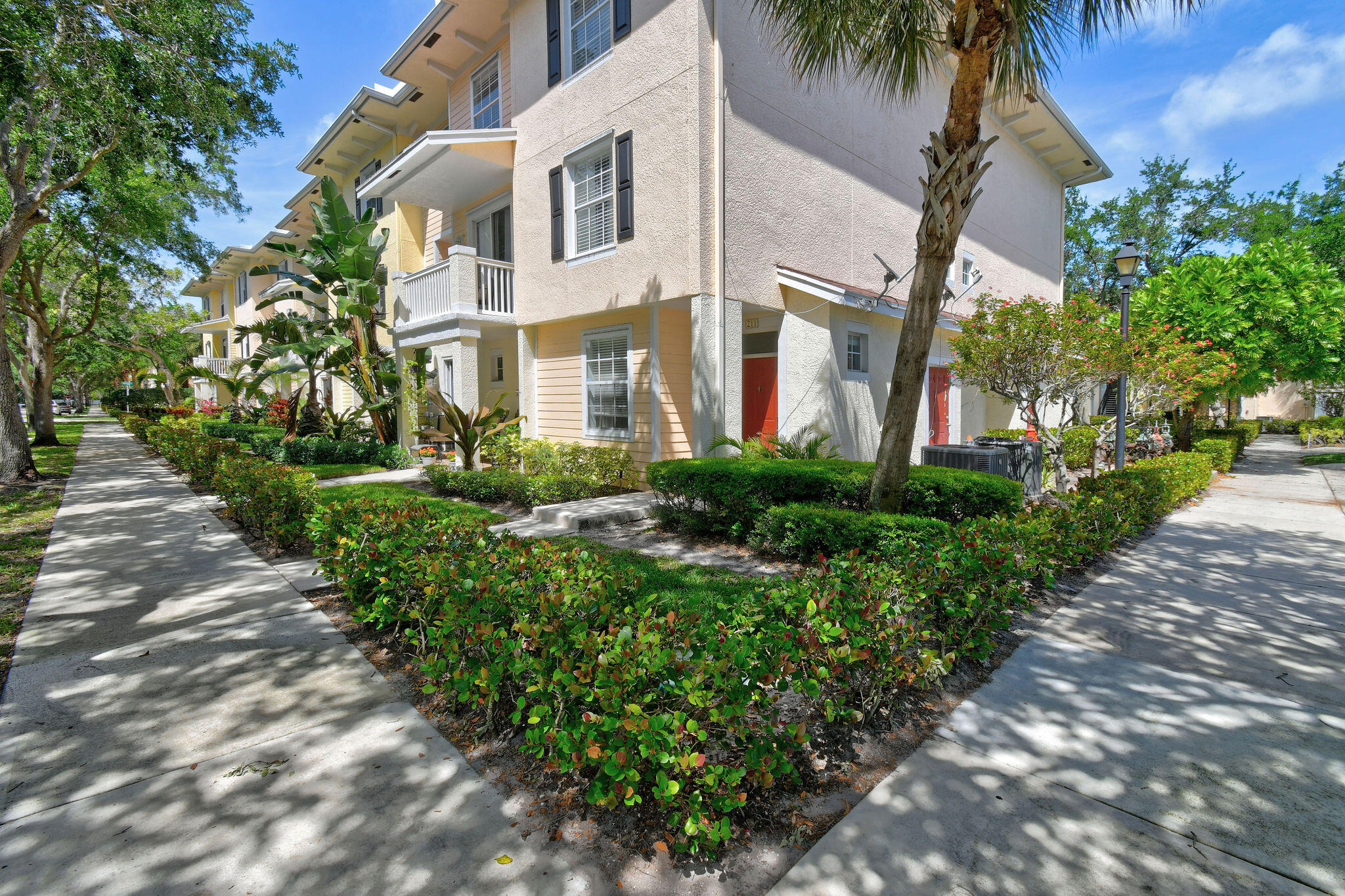 175 Galicia Way, Unit 211 Jupiter, FL 33458 - Photo 31 of 49 a front view of a house with a garden
