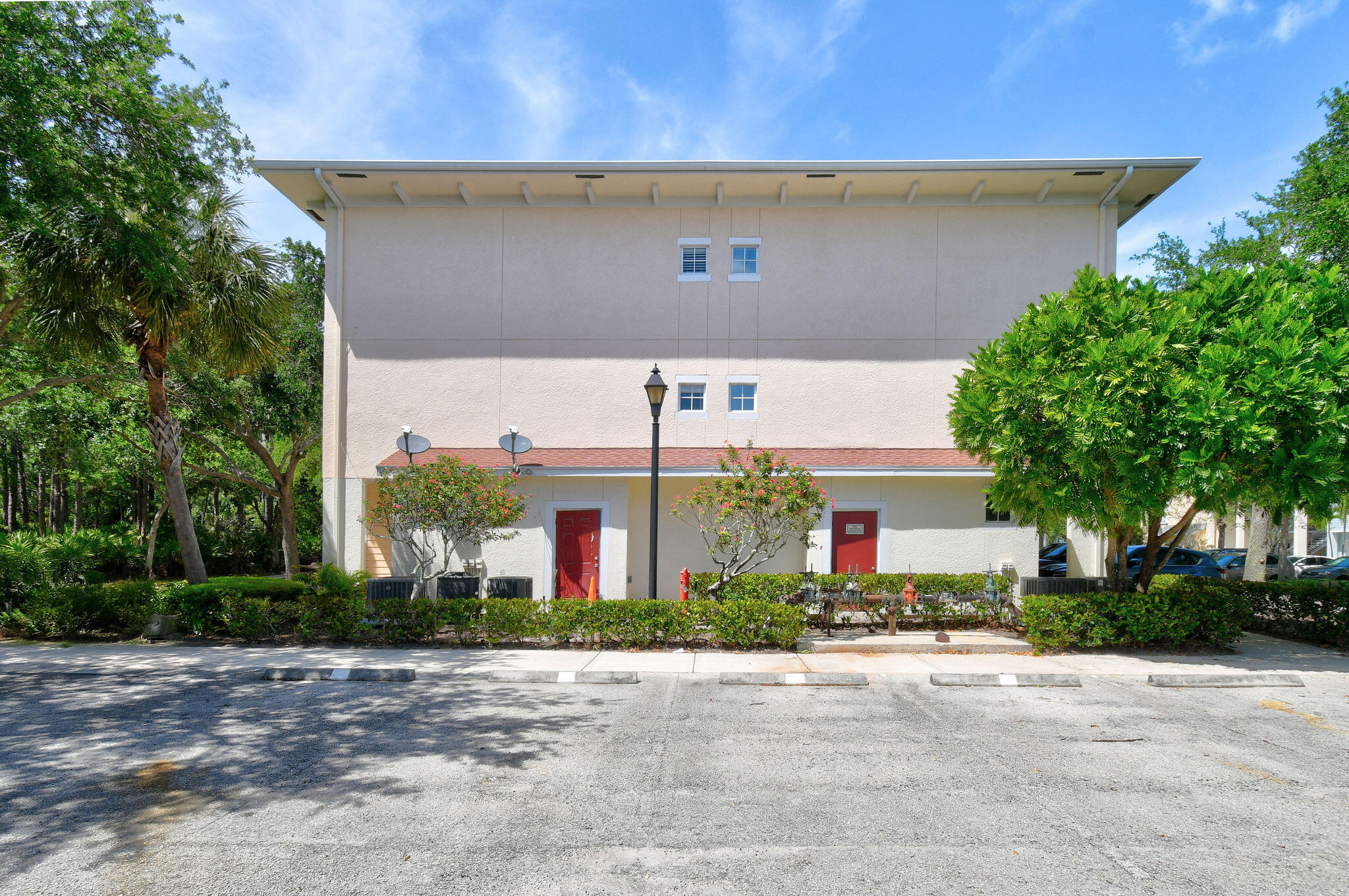 175 Galicia Way, Unit 211 Jupiter, FL 33458 - Photo 32 of 49 a front view of house with garage and yard
