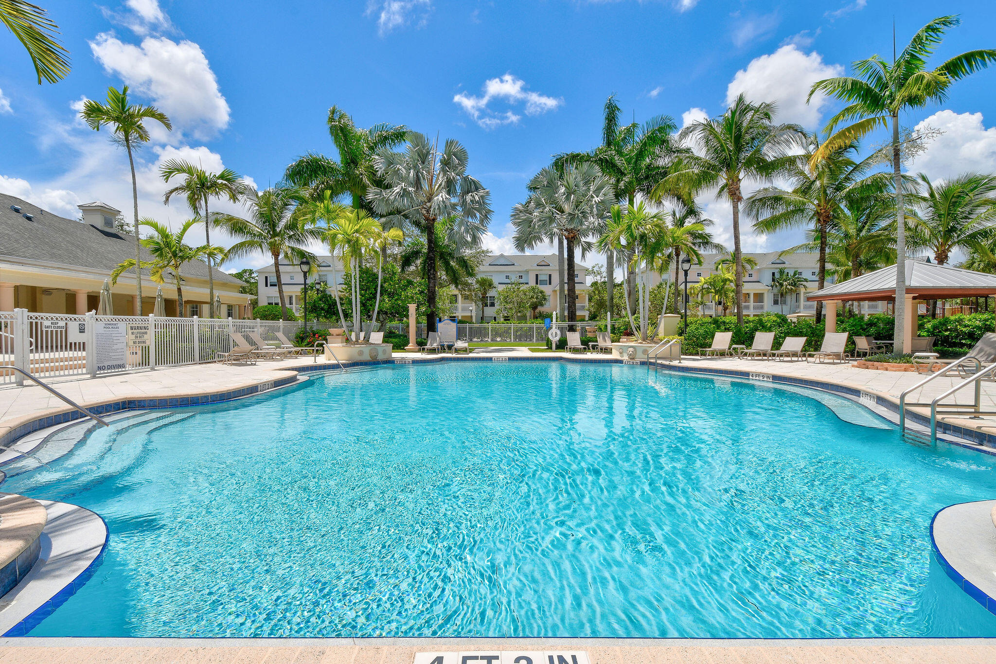 175 Galicia Way, Unit 211 Jupiter, FL 33458 - Photo 34 of 49 a swimming pool with outdoor seating and yard