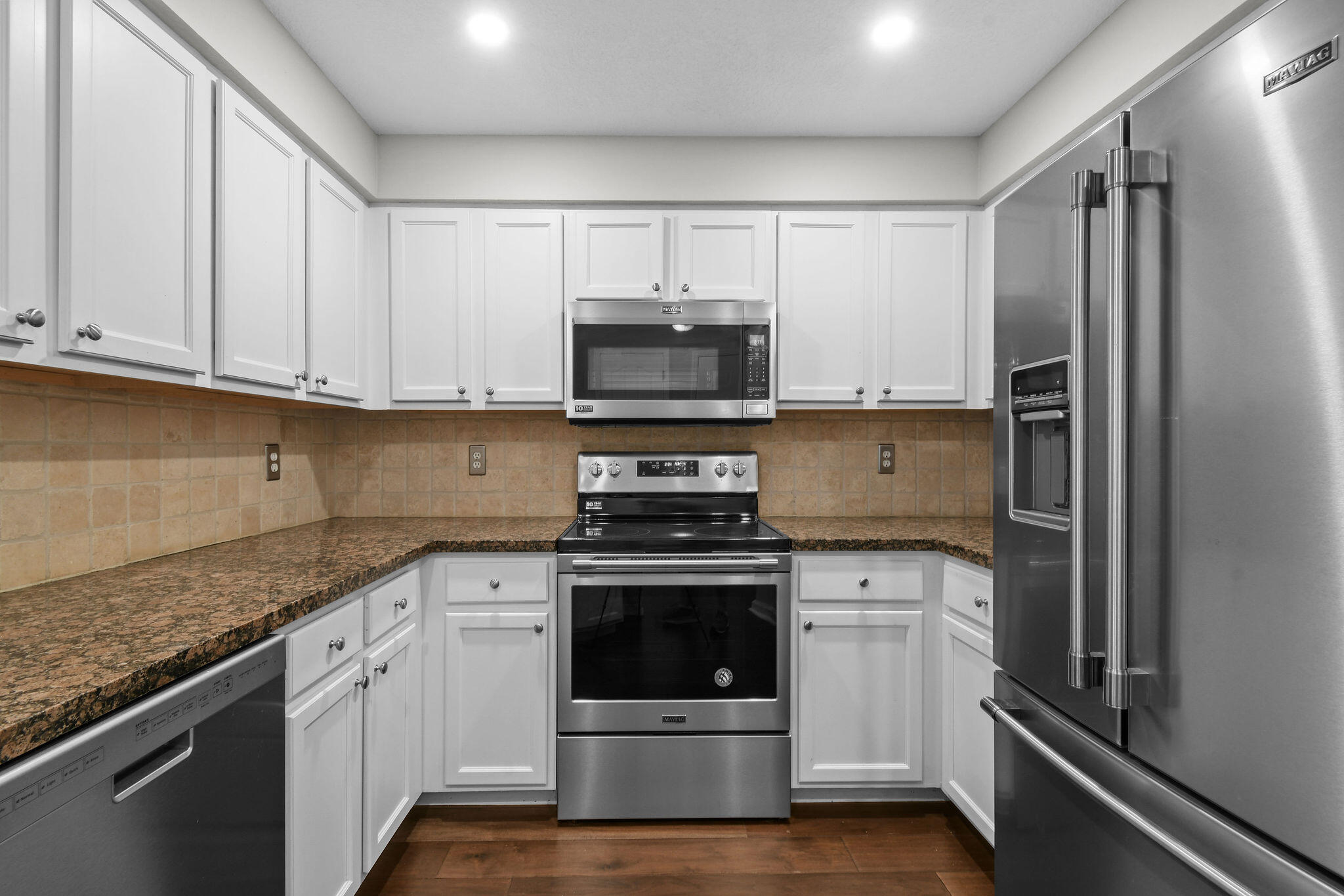 175 Galicia Way, Unit 211 Jupiter, FL 33458 - Photo 5 of 49 a kitchen with a stove and a refrigerator