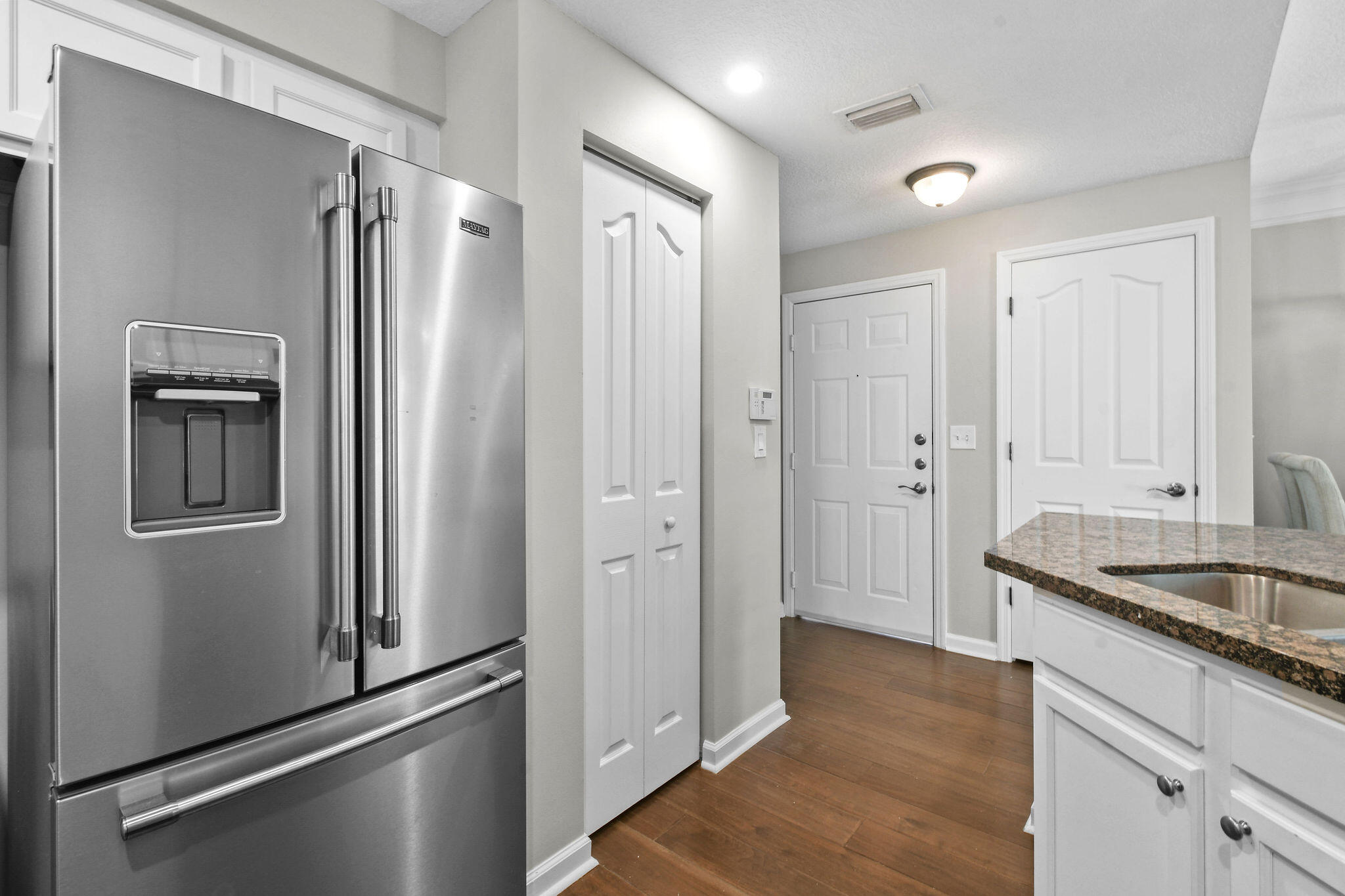 175 Galicia Way, Unit 211 Jupiter, FL 33458 - Photo 6 of 49 a kitchen with stainless steel appliances granite countertop a refrigerator and a sink