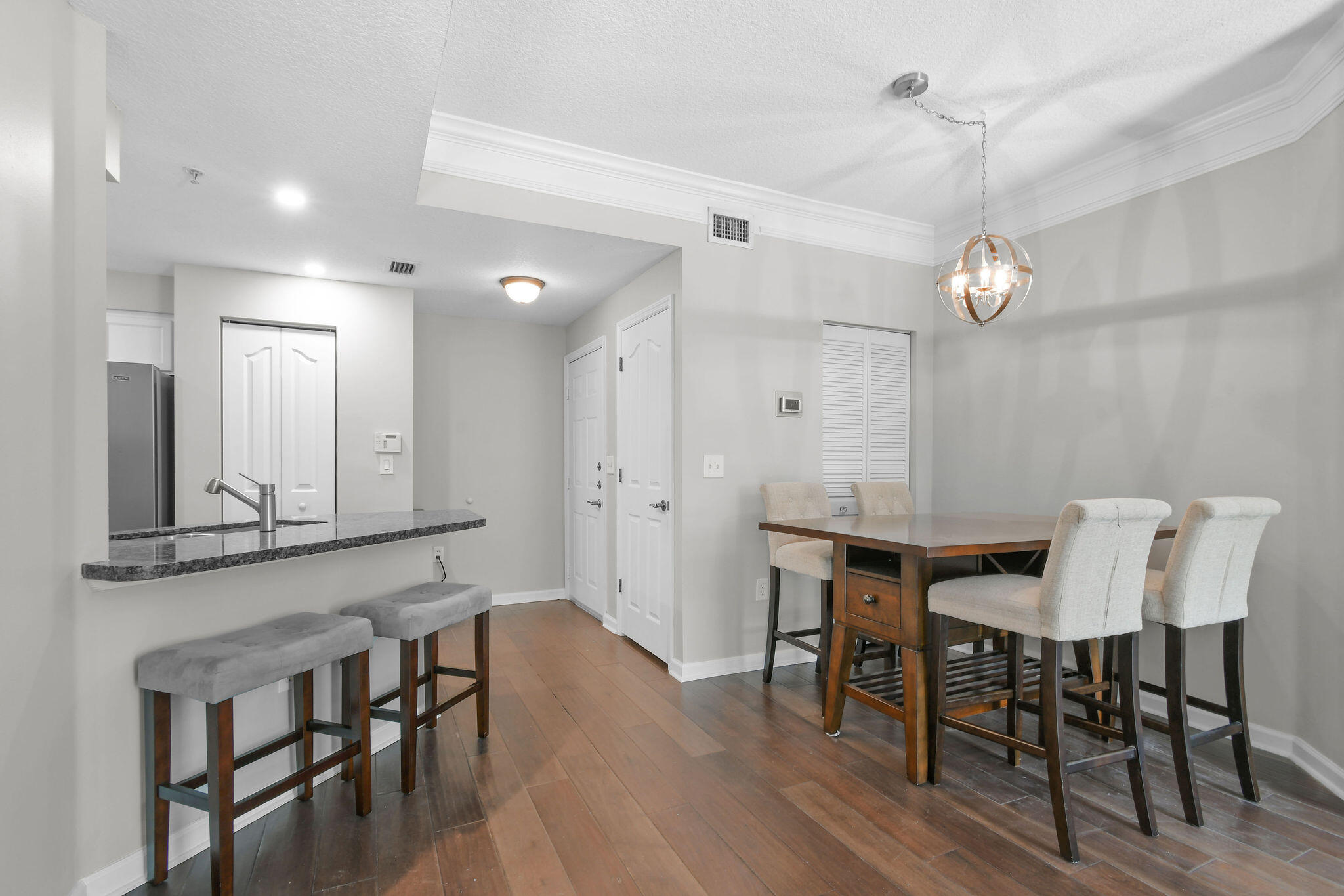 175 Galicia Way, Unit 211 Jupiter, FL 33458 - Photo 8 of 49 a view of a a dining room with furniture window and wooden floor