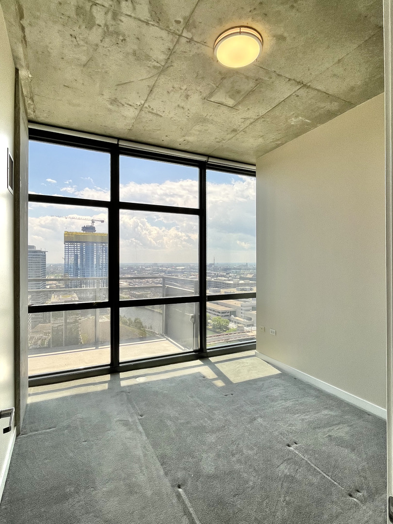 235 West Van Buren Street, Unit 2604 Chicago, IL 60607 - Photo 12 of 21 a view of an empty room with a window