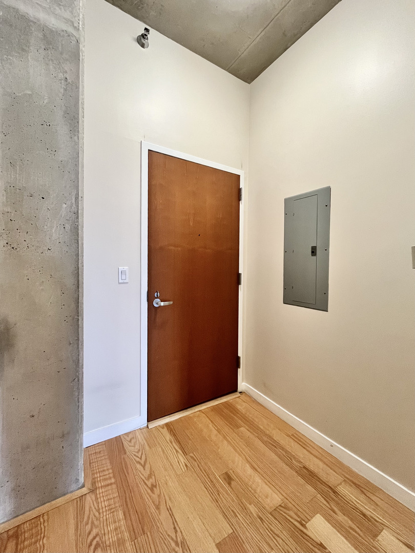 235 West Van Buren Street, Unit 2604 Chicago, IL 60607 - Photo 5 of 21 a bedroom with a bed and a mirror