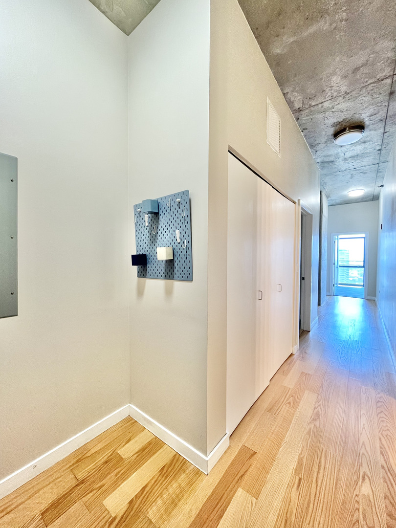 235 West Van Buren Street, Unit 2604 Chicago, IL 60607 - Photo 6 of 21 a view of a hallway with wooden floor