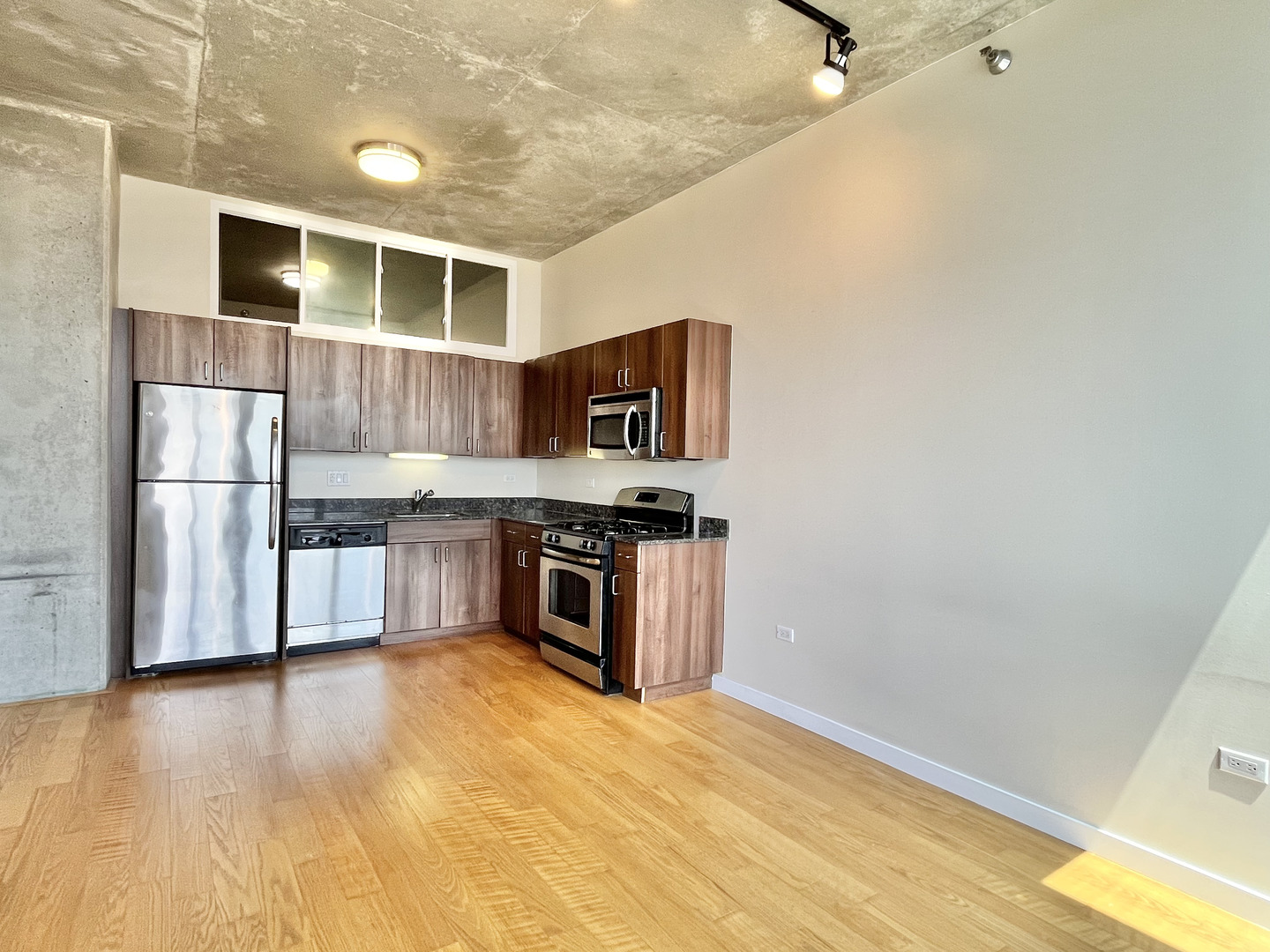 235 West Van Buren Street, Unit 2604 Chicago, IL 60607 - Photo 10 of 21 a kitchen with stainless steel appliances granite countertop a refrigerator and a stove