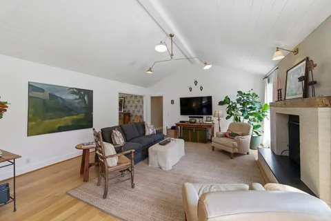 a living room with furniture a flat screen tv and a fireplace