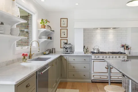 a kitchen with a sink stove and cabinets
