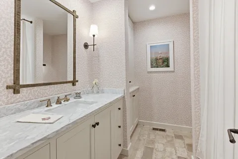a bathroom with a double vanity sink and mirror