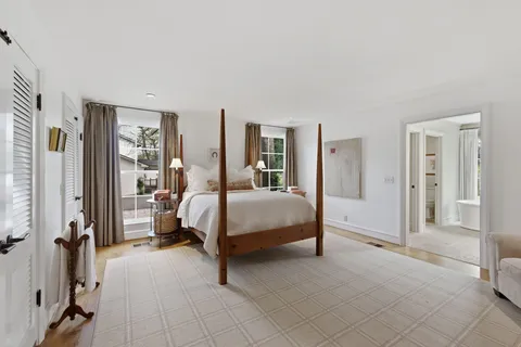 a bedroom with a bed and a mirror