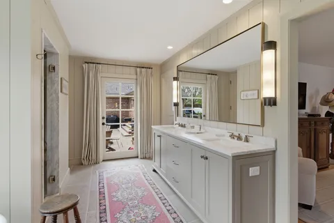 a spacious bathroom with a sink a mirror and a shower