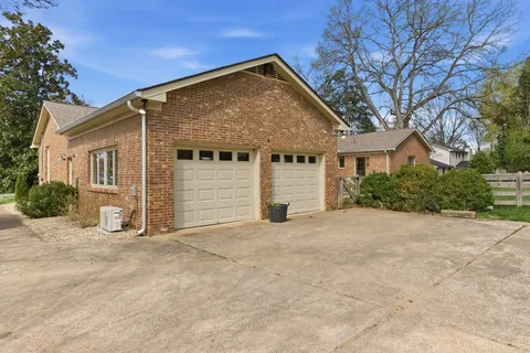 a view of a house with a yard and garage
