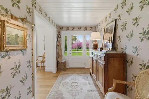 a view of entryway with furniture and wooden floor