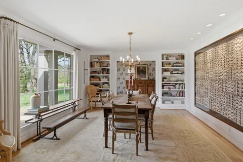 a dining room with furniture and a window