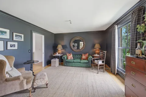 a view of a livingroom with furniture and a wooden floor