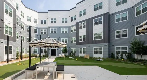 a front view of a building with a garden