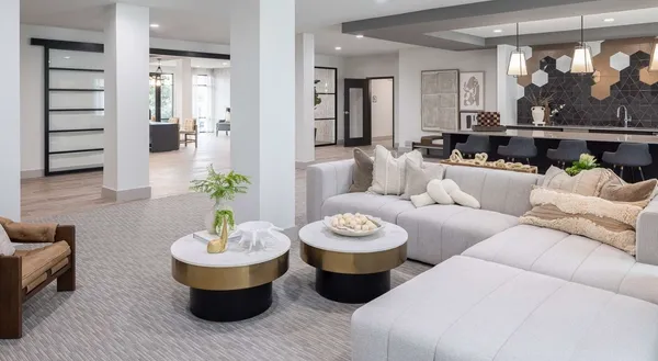 a living room with furniture and view of kitchen