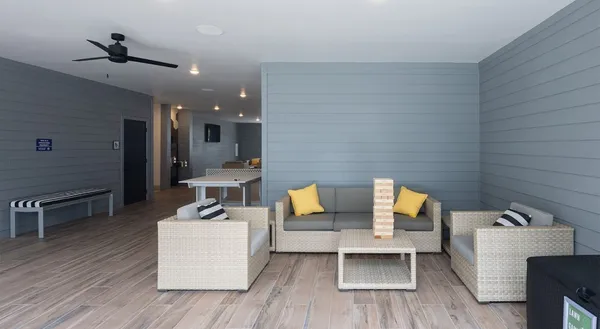a living room with furniture and wooden floor