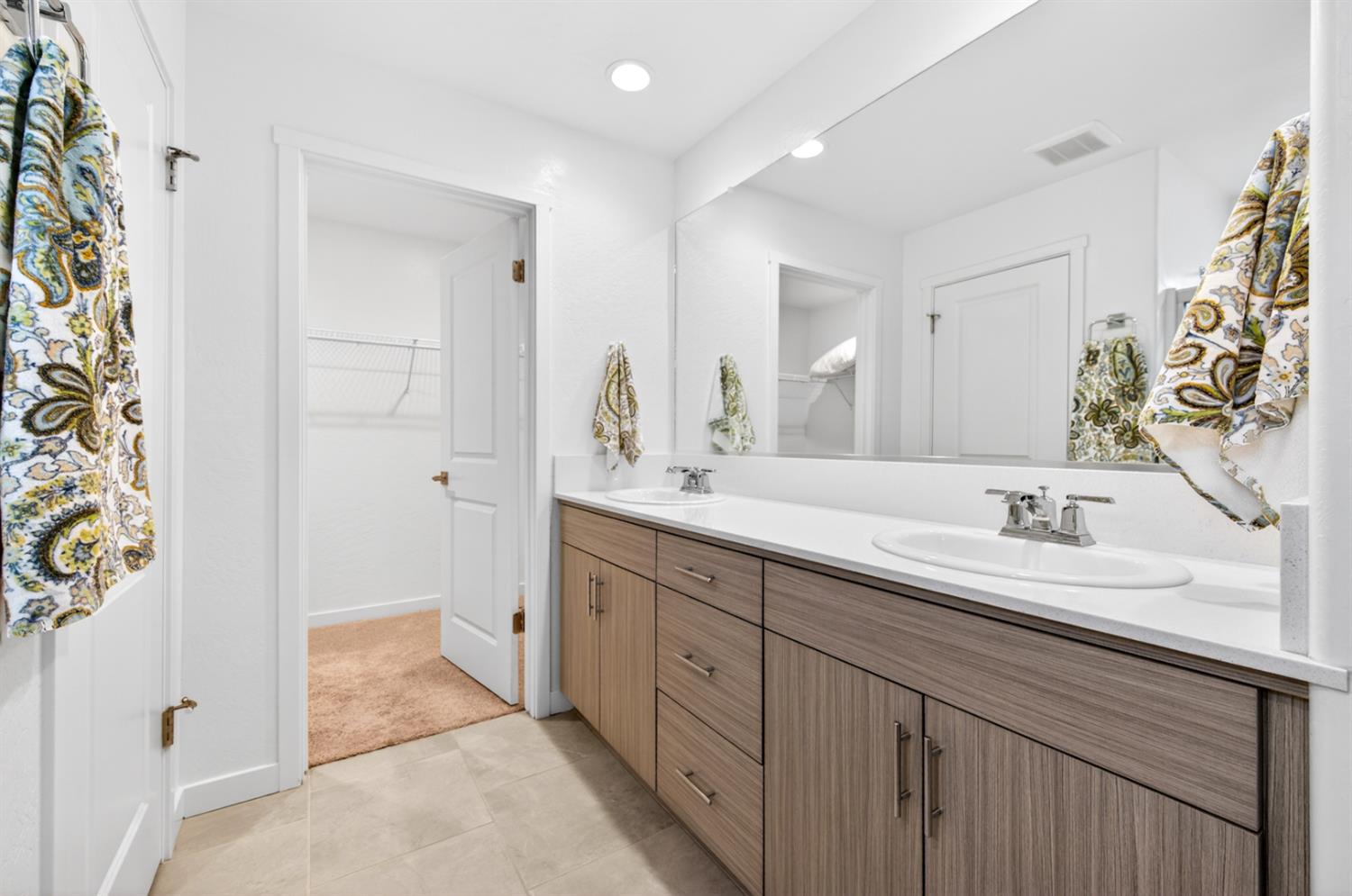 317 Talus Way South Madera, CA 93636 - Photo 33 of 61 a spacious bathroom with a double vanity sink a mirror and shower