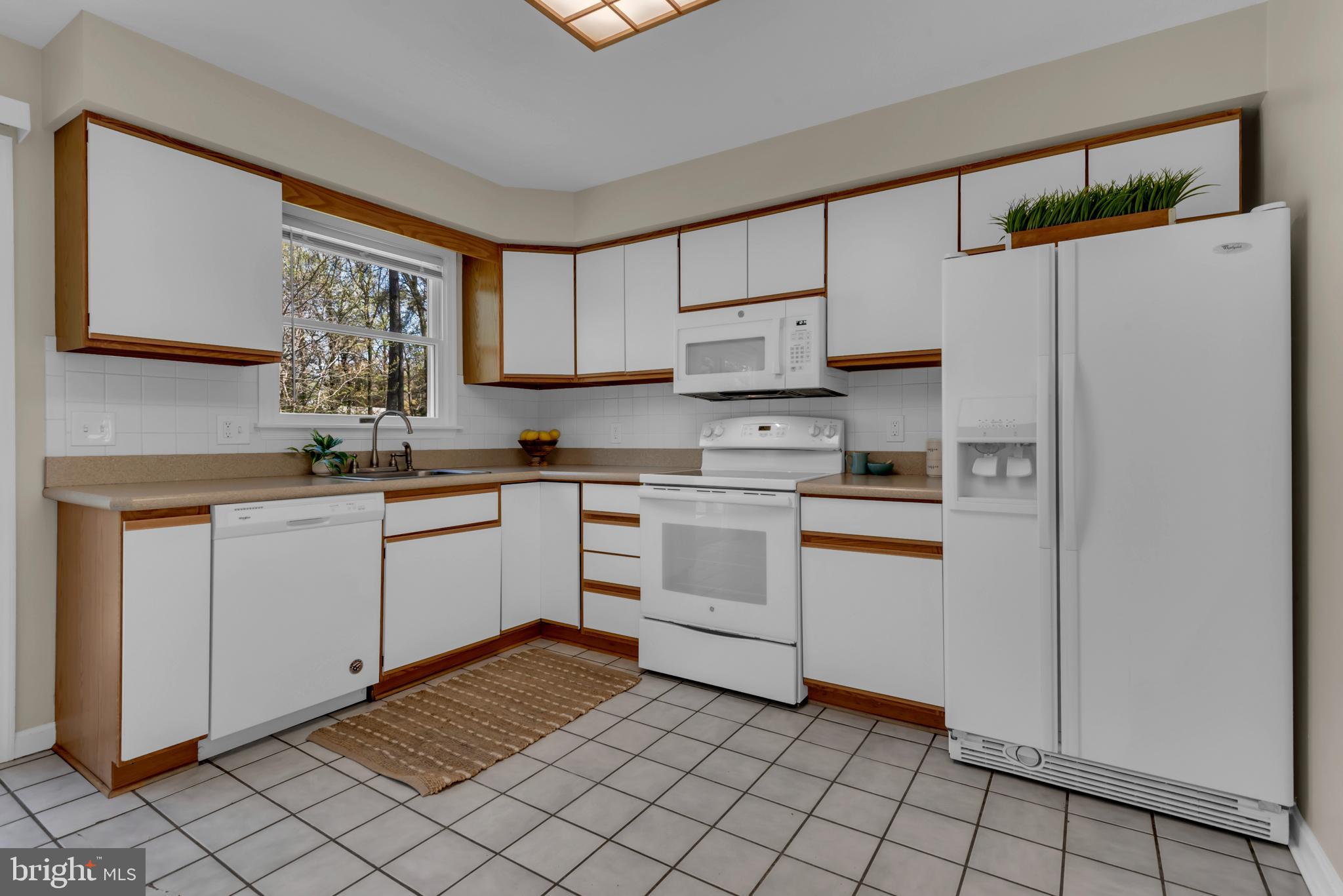 320 McKay Road Stevensville, MD 21666 - Photo 16 of 48 a kitchen with white cabinets and white appliances