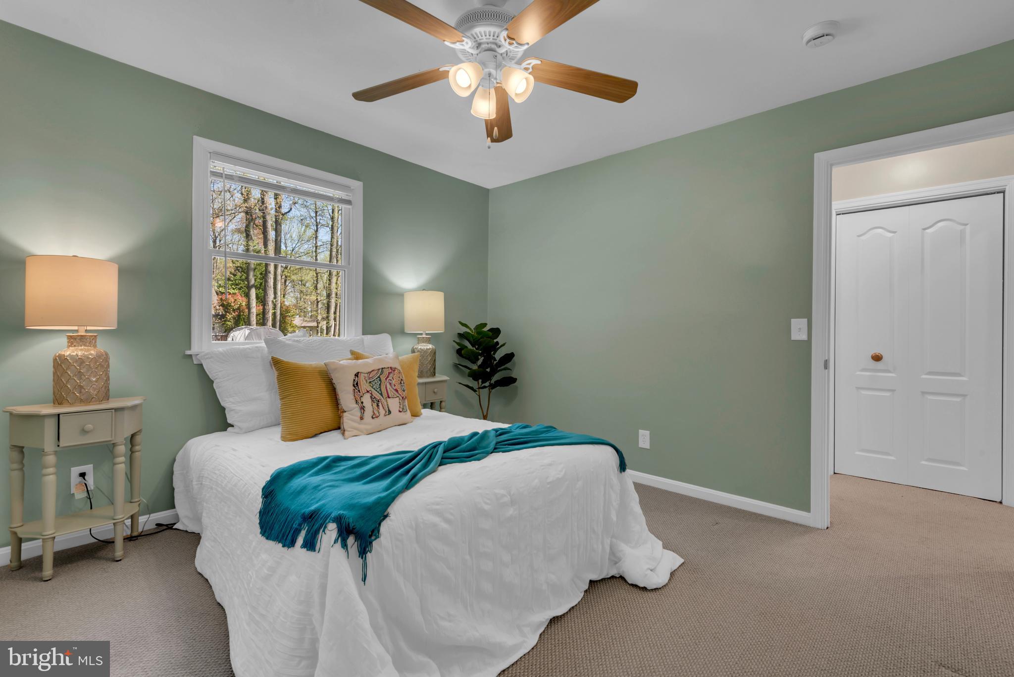 320 McKay Road Stevensville, MD 21666 - Photo 24 of 48 a bedroom with a bed and a chandelier
