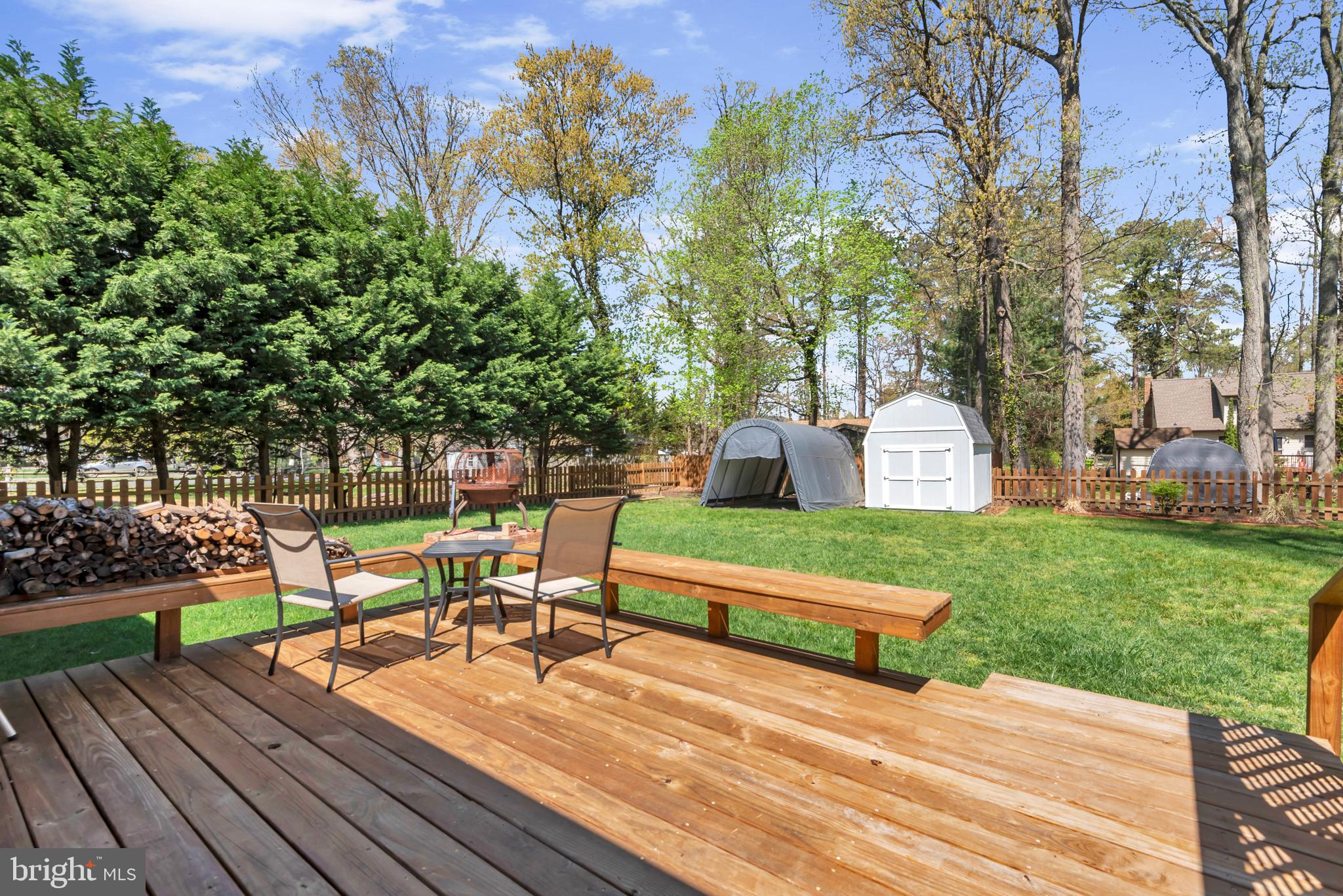 320 McKay Road Stevensville, MD 21666 - Photo 33 of 48 a view of table and chairs in patio with wooden fence