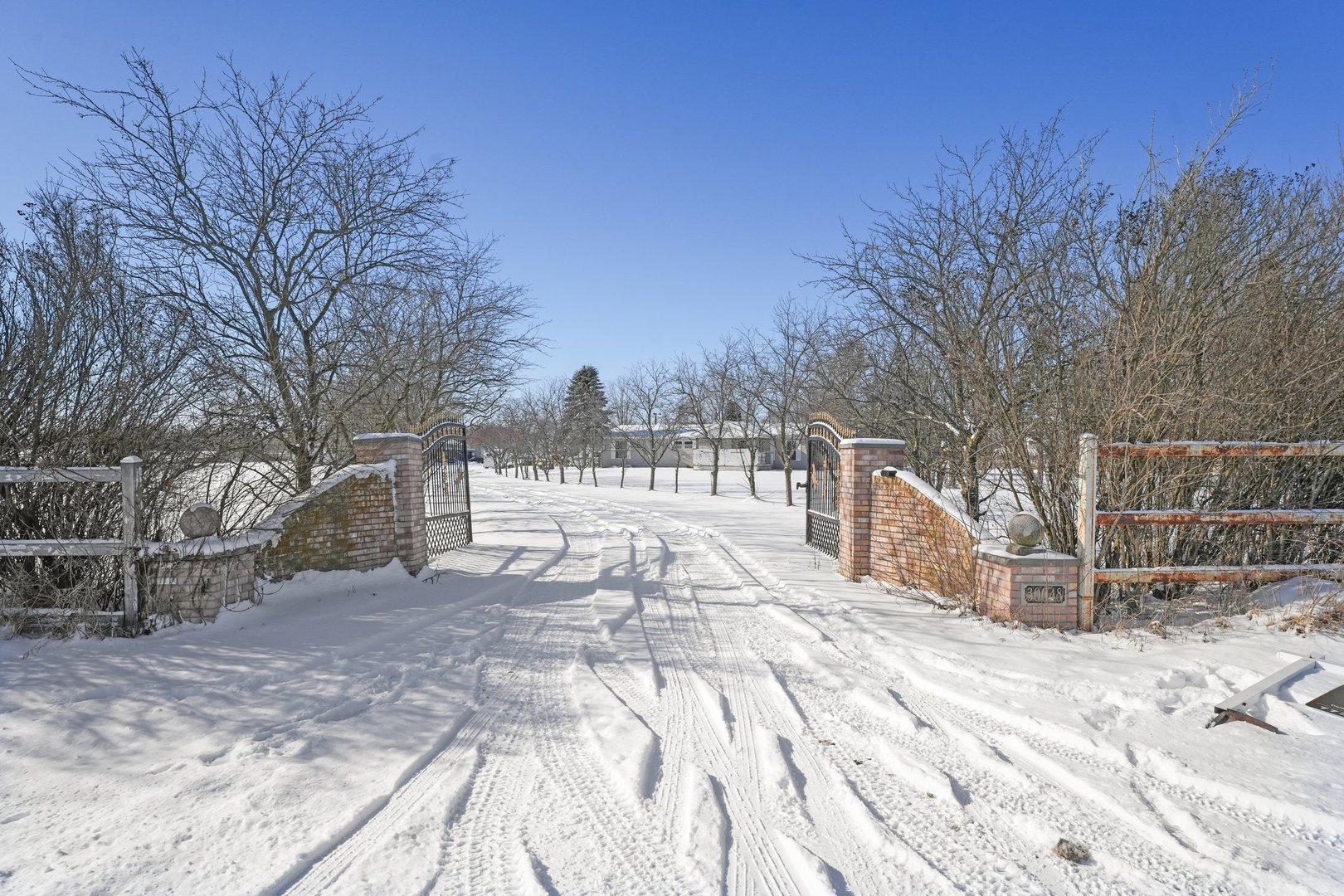 a view of yard covered with snow in front of house