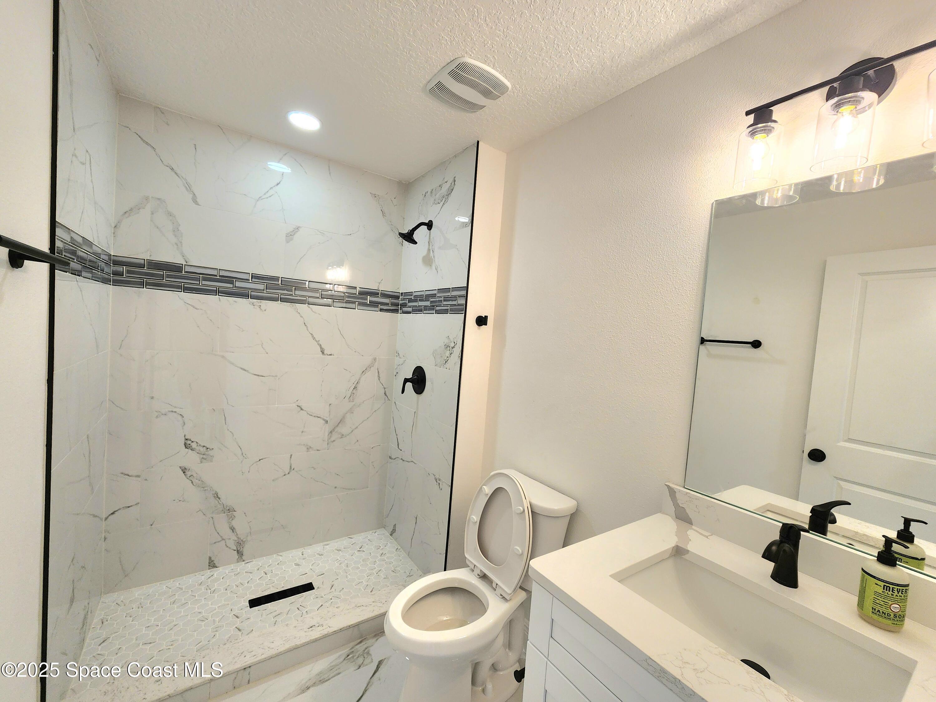 710 Bryant Road Palm Bay, FL 32908 - Photo 12 of 26 a bathroom with a sink toilet and shower