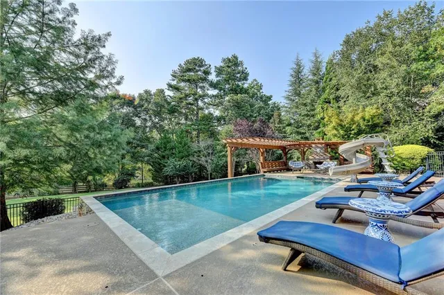 a kitchen with stainless steel appliances a dining table and chairs
