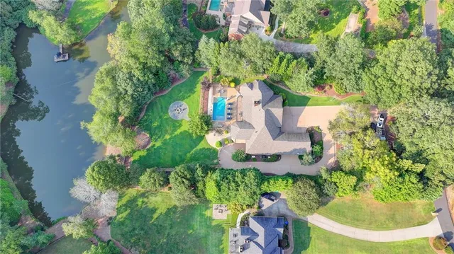 a kitchen with granite countertop a sink stove cabinets and refrigerator