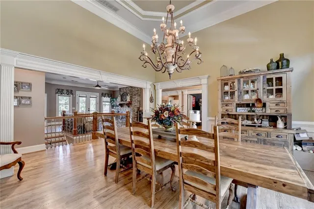 a kitchen with stainless steel appliances granite countertop a sink a stove top oven a chimney and a center island