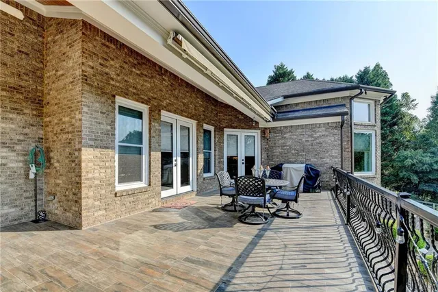 a view of a house with backyard and a sitting area