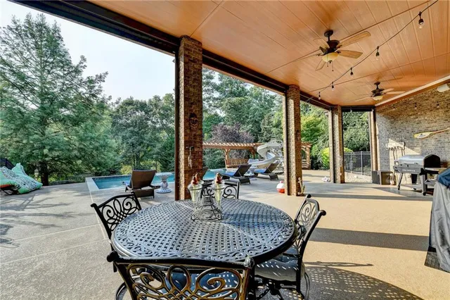 a view of a house with a yard table and chairs