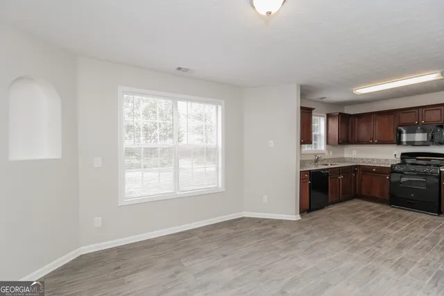 a large kitchen with a stove a sink and a refrigerator