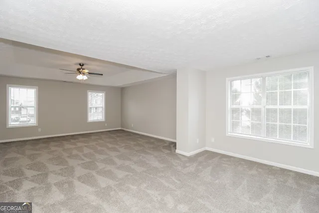 an empty room with windows and closet