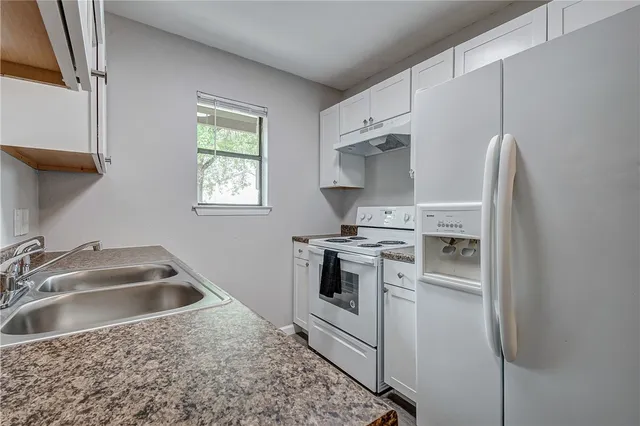 a kitchen that has a sink and a stove
