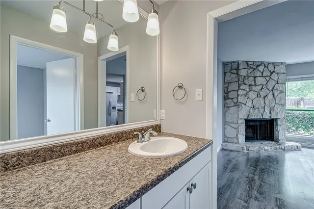 a white toilet and tub sitting next to a bathroom sink