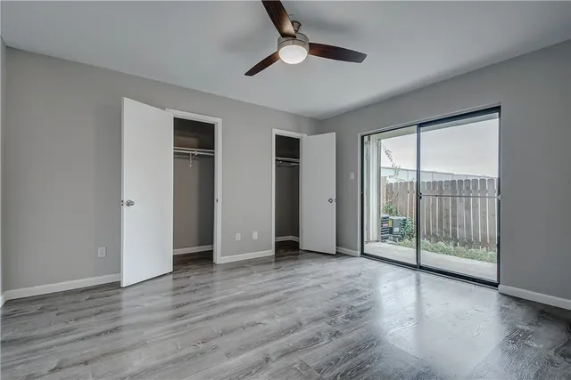 a view of a backyard with wooden fence