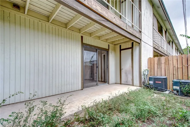a view of a porch with furniture and a backyard