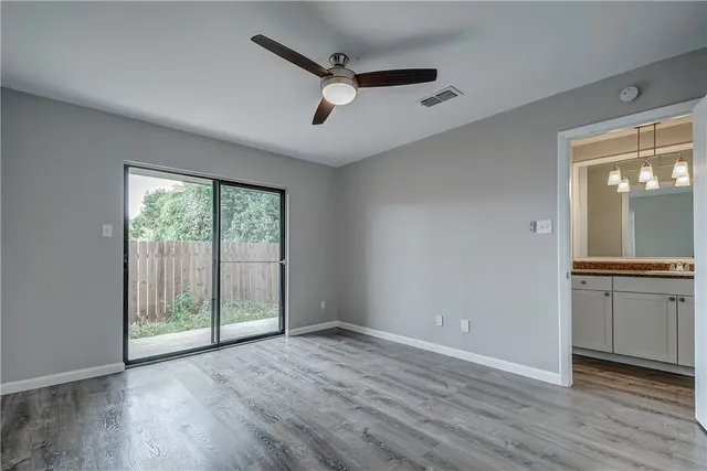wooden floor in an empty room with a window