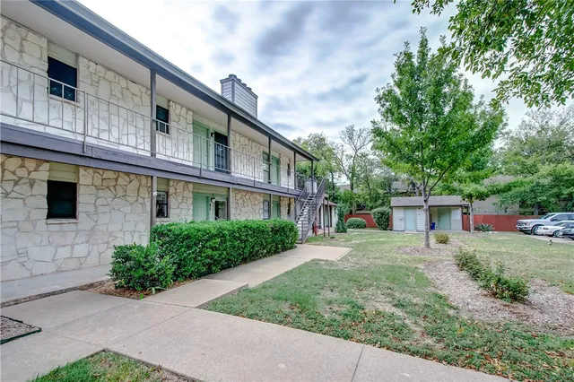 a living room with a fireplace and a large window