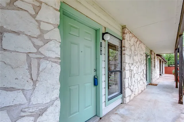 a view of a kitchen with a sink wooden floor and a fireplace