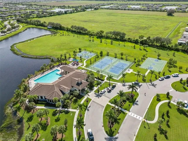 an aerial view of residential houses with outdoor space and swimming pool